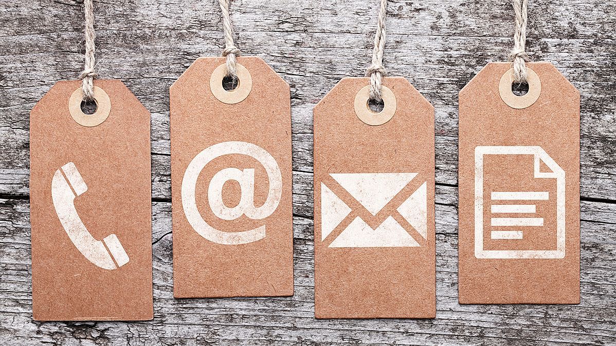 Four cardboard labels showing the symbols for phone, website, email address and documents.  